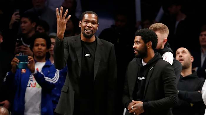 Kevin Durant and Kyrie Irving on the sideline.